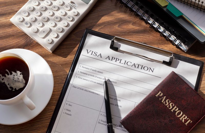 Visa Application and foreign Passport sitting on a desk